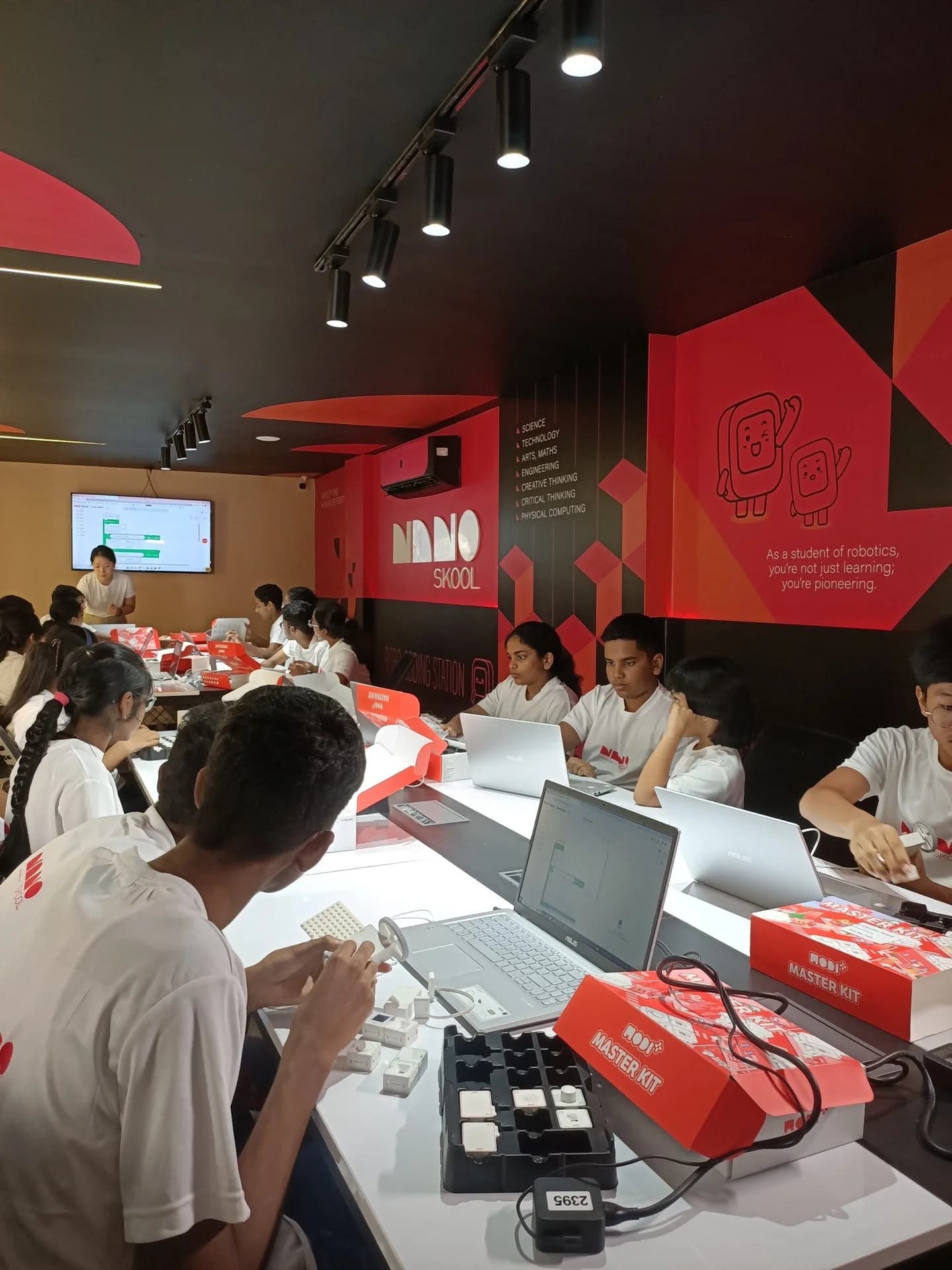 Students building with robotics modules in a NanoSkool classroom
