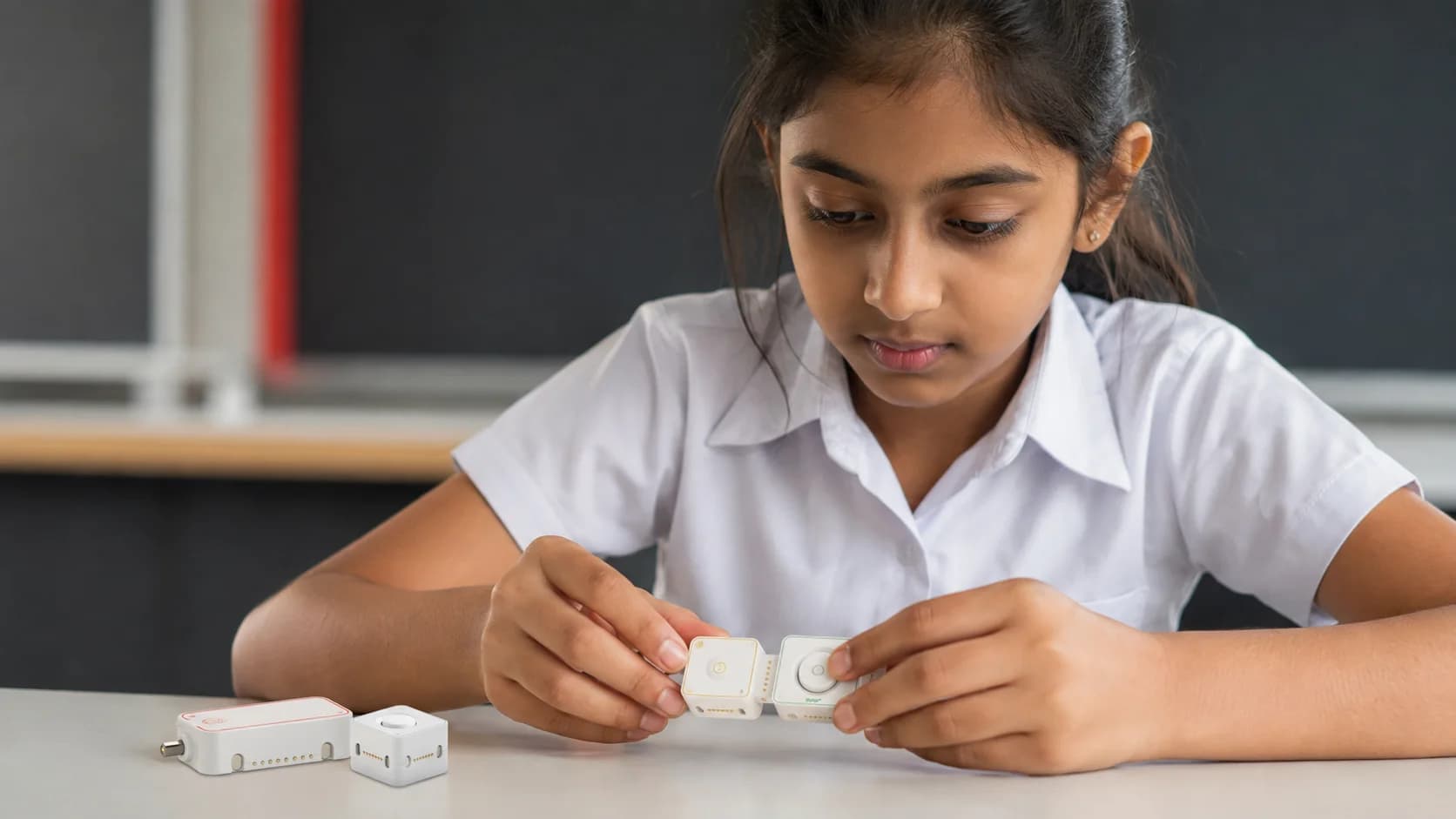 Illustration of a student connecting small MODI button and network modules
