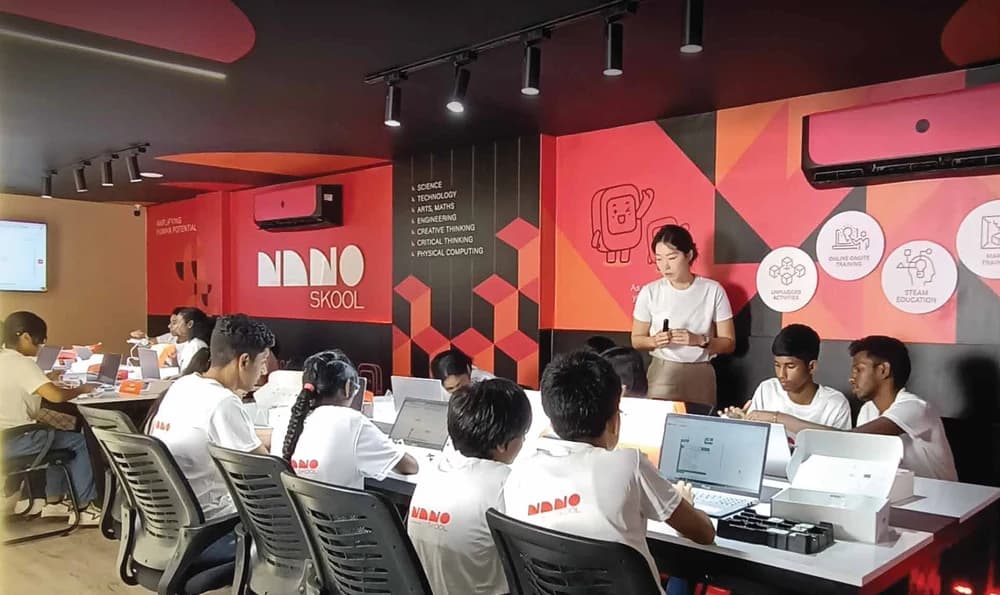 An educator guiding students in a NanoSkool classroom